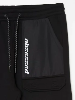 Cropp Spodnie*Czarne dresowe joggery z efektem reflective czarny